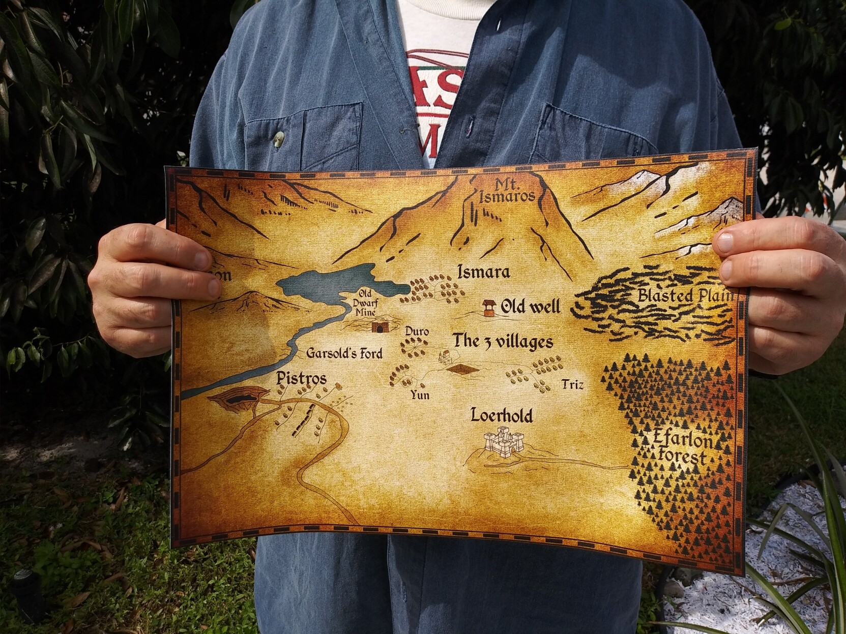 Person holding the full color reproduction of the map from The Amulet and the Dragon